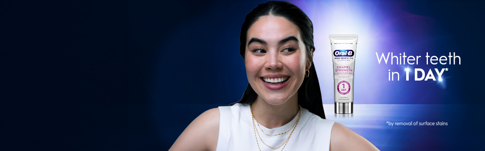 Oral-B Pro 3D White Clinical Enamel Strength toothpaste showing next to a smiling model