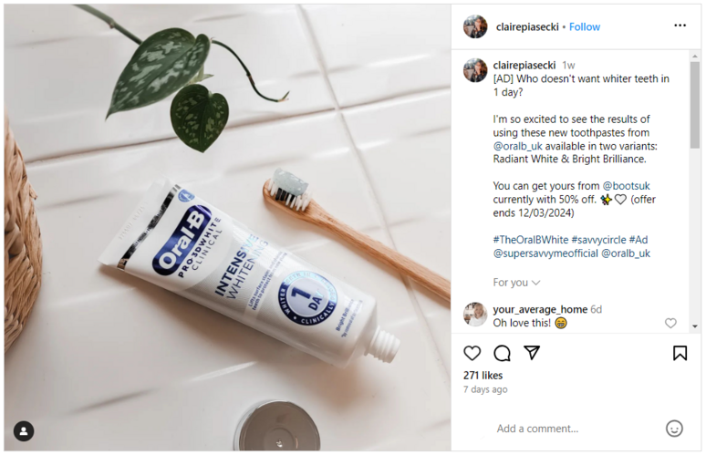 Oral-B tube with a wooden bush next to it