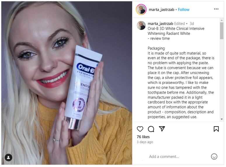 Woman smiling with a tube of Oral-B intensive Whitening