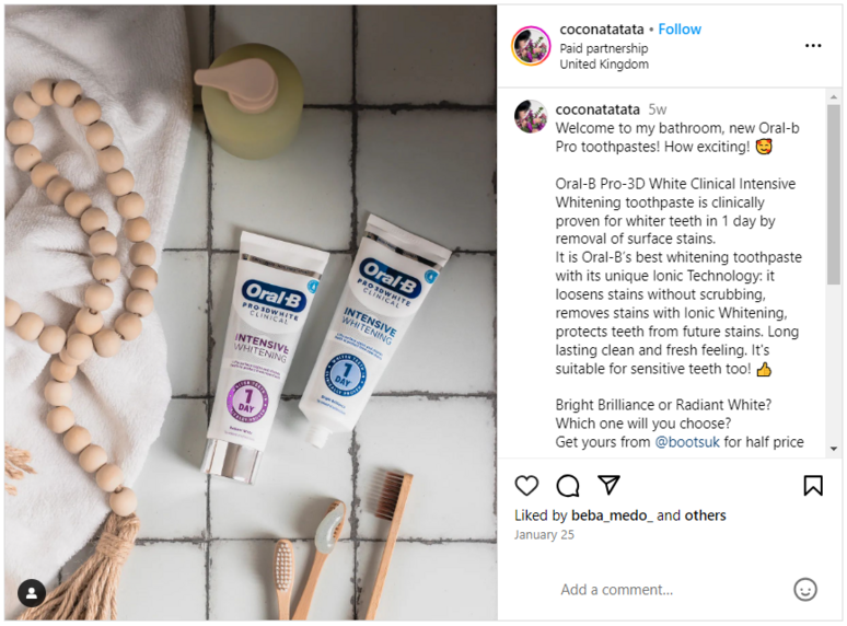 Tubes of Oral-B with wooden toothbrushes, soap, and some wooden beads 